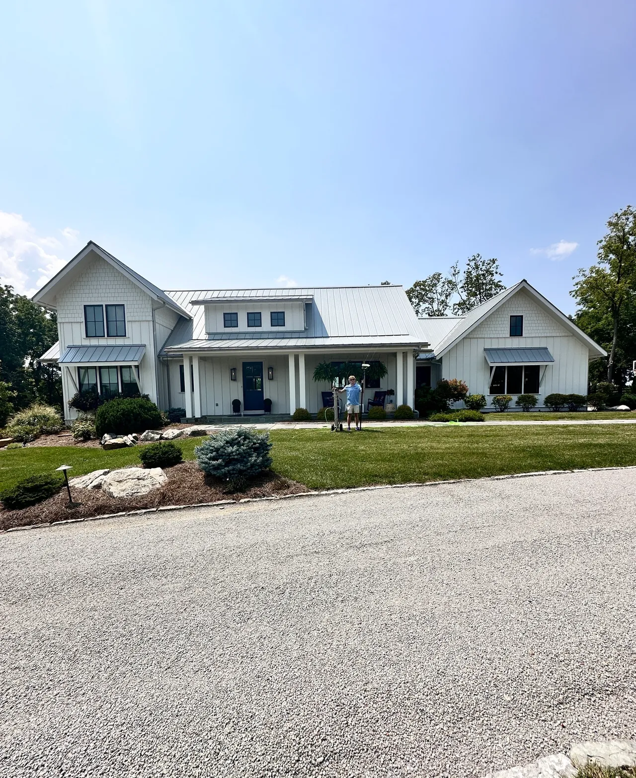 White house with a spacious front yard.
