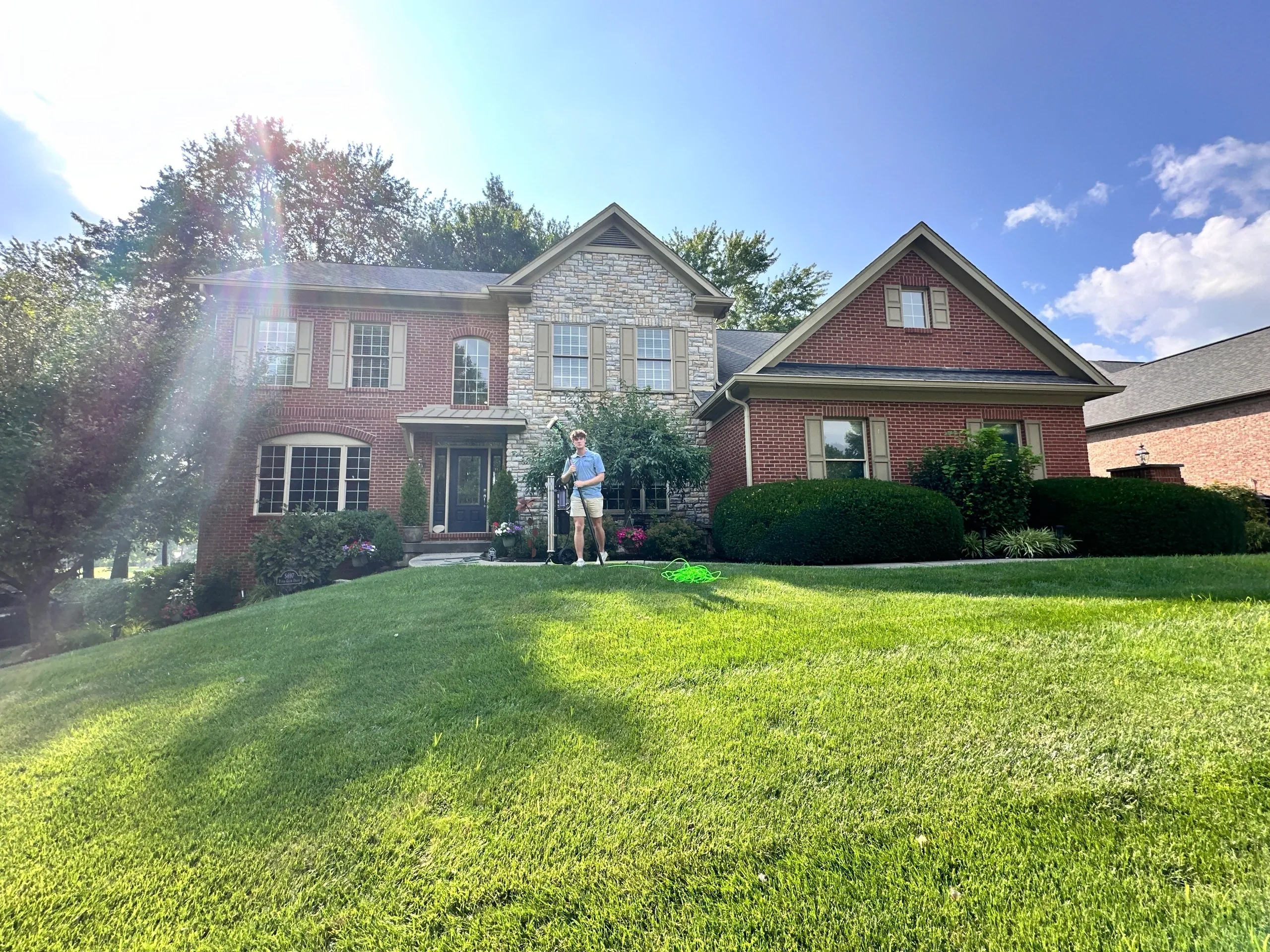 Family standing in front of large house.
