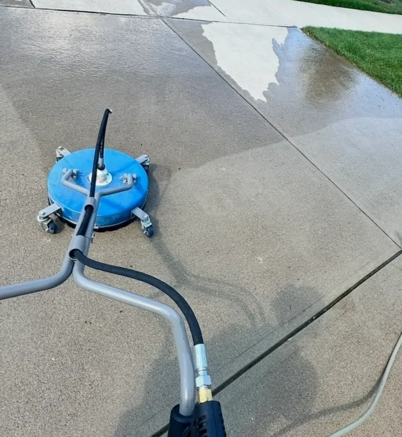 rs=w_800,h_1067,cg_true (1) (1) Power washer cleaning a concrete driveway surface.