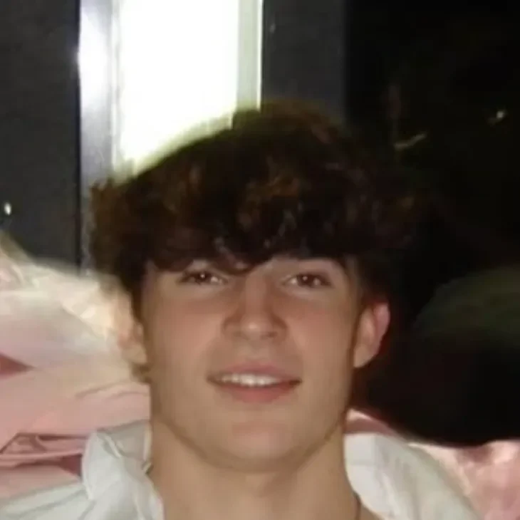 andrew Smiling person with dark hair indoors.