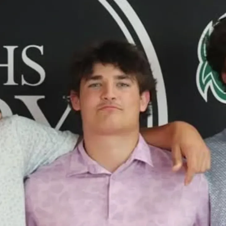 nick-maxwell Young man posing, wearing a pink shirt.