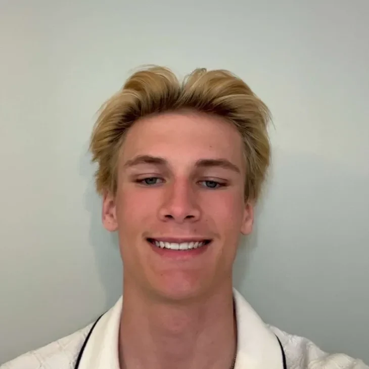 ryder Smiling person with blonde hair, light background.